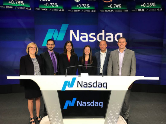 Ace3 Team at NASDAQ opening standing at podium.