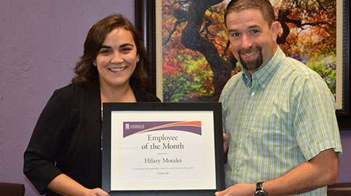 Hilary Morales holding Award