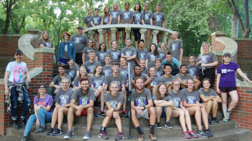 Honors students on steps posing for photo