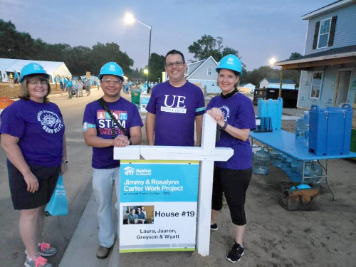 Beth Folz, Mark Valenzuela, Chuck Meacham, and Holly Carter by Habitat House sign