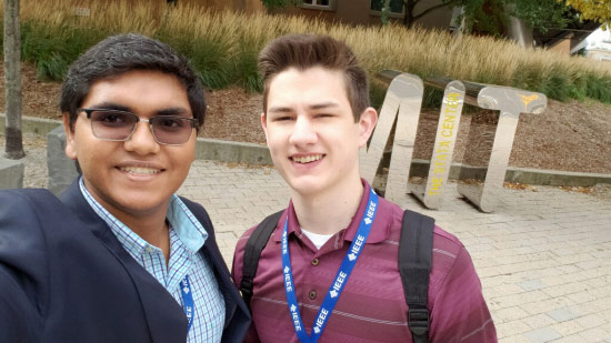 Mukjerhee and Elliott in front of MIT sign