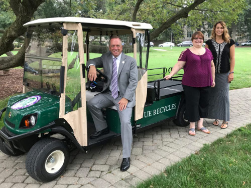 UE President sitting in the new Recycling Golf Cart