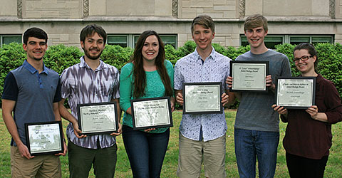 Six smiling students holding awards