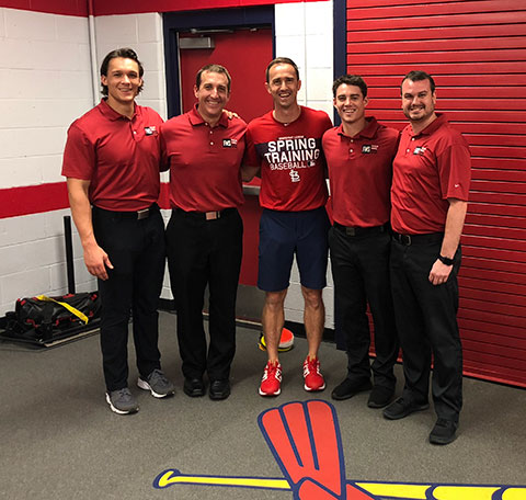 Five men in red shirts