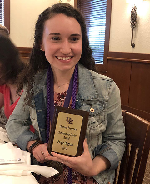 Paige holding her award