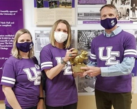 three people in masks.