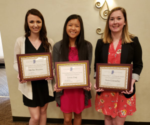 Students holding plaques