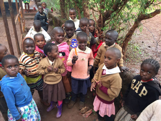 Kenya children holding up Ace Purple