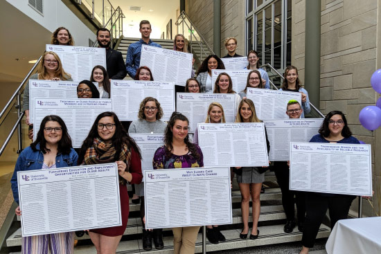 Sociology students holding posters